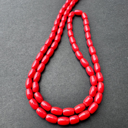 Close-up of Coral stone beads showing smooth drum cut and natural gemstone texture.