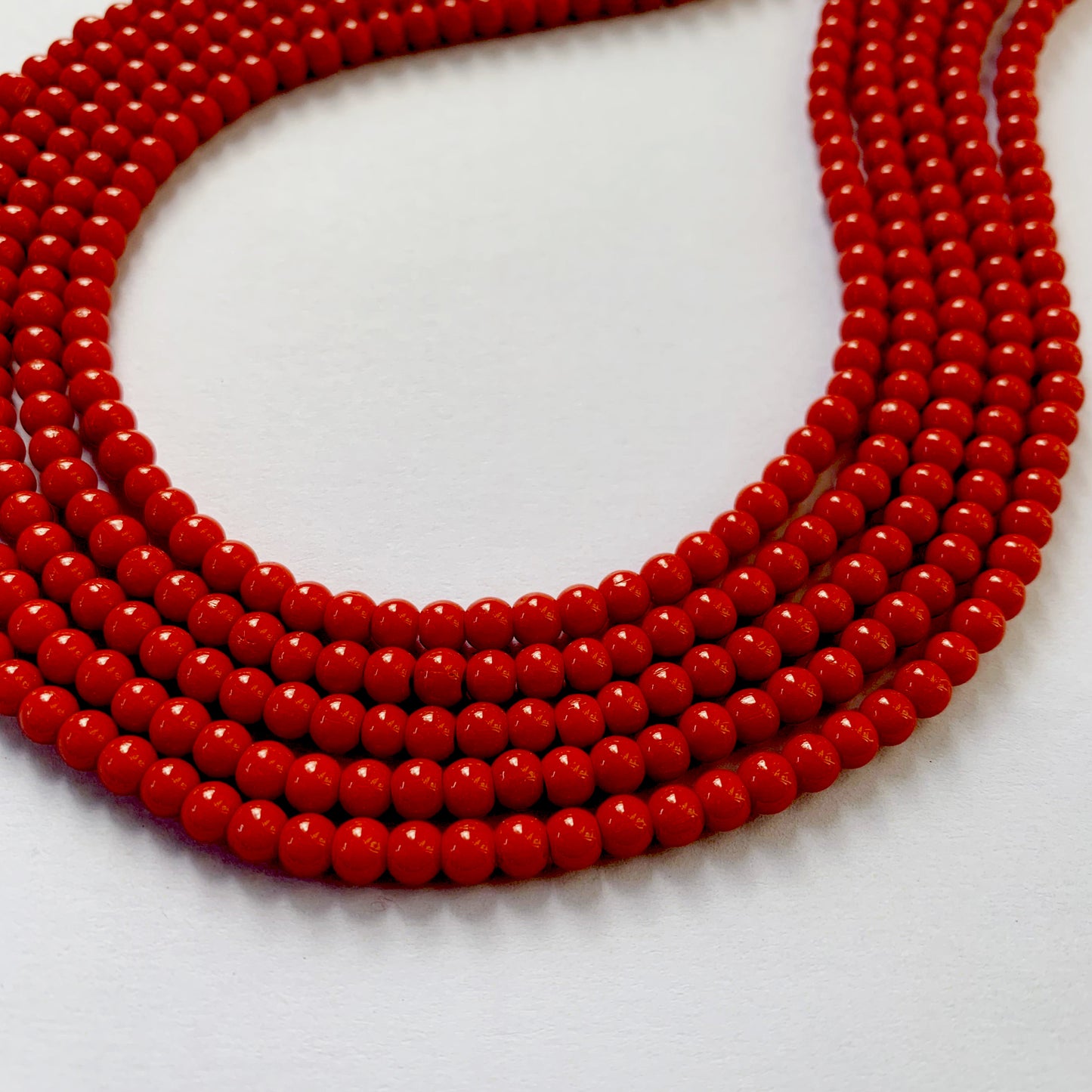 4.3-4.5mm coral beads strung with uniformity, ideal for jewellery projects.