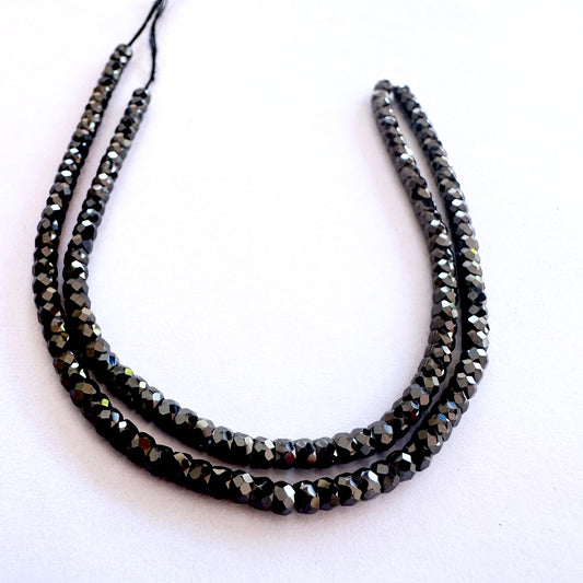 Close-up of 3mm Black Cubic Zirconia beads showing uniform shape and high-quality sparkle.