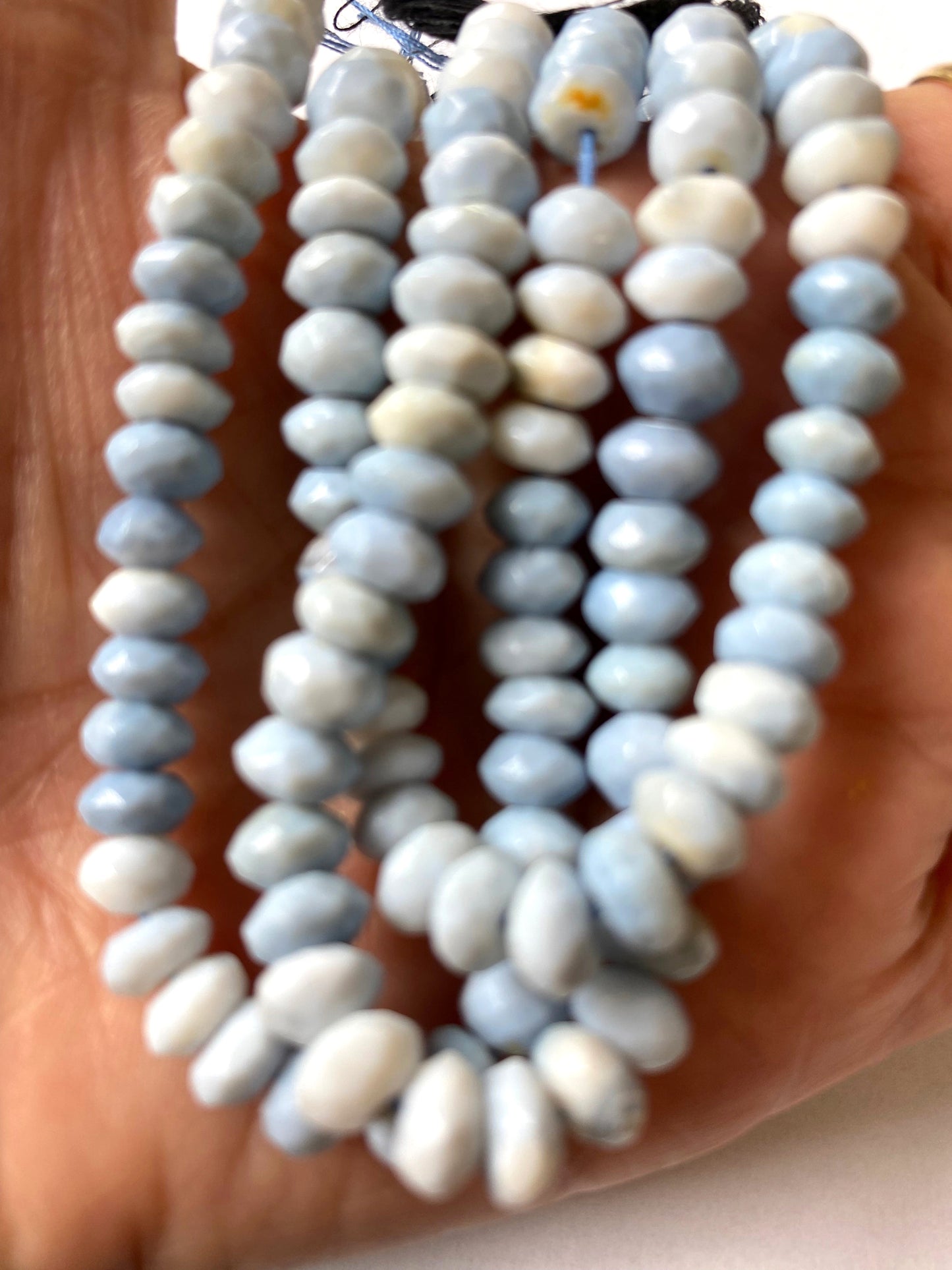 Denim Blue Opal gemstone beads sparkle under soft light, enhancing their refined colour and brilliance.
