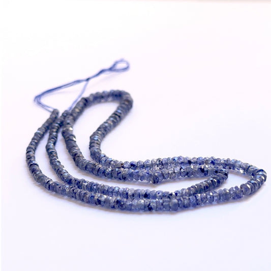 Close‑up of Blue Sapphire 3–4mm faceted rondelle beads highlighting crisp facets and intense blue colour.