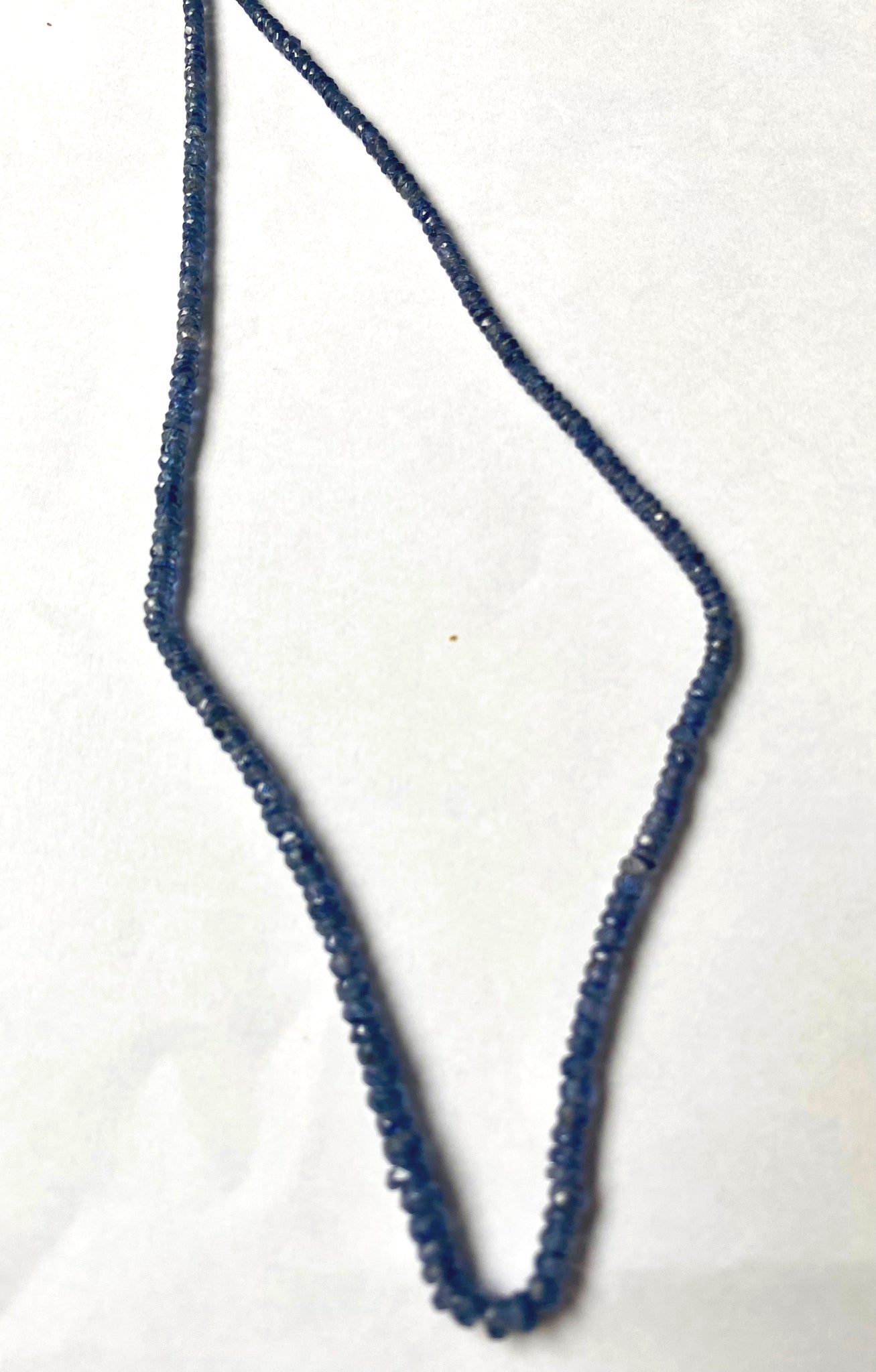 Vibrant Denim Blue Sapphire rondelle gemstones aligned evenly with shimmering polish and clarity.