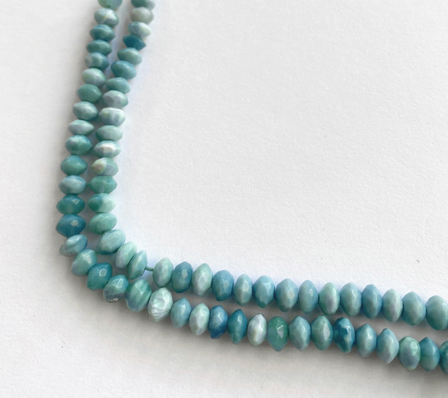 Strand of denim opal beads with 6.5–6.7mm size, showcasing their subtle sparkle and smooth polish.