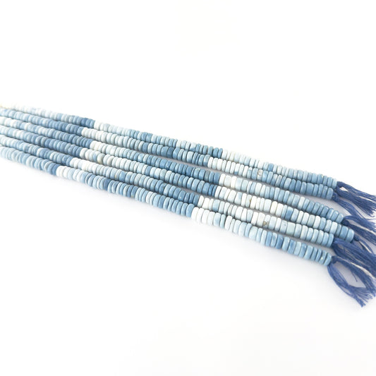 Denim Opal smooth wheel gemstones with muted blue colour and clean rounded shaping across a 20cm strand.
