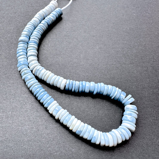 Close-up of Denim Opal stone beads showing smooth cut and natural gemstone shine.