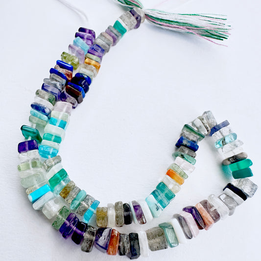 Close-up of Disco smooth heishi beads showing polished surface and uniform size.