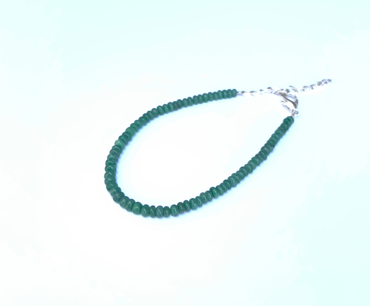 Handcrafted Beryl Emerald bracelet showcasing smooth rondelle beads and radiant shine.