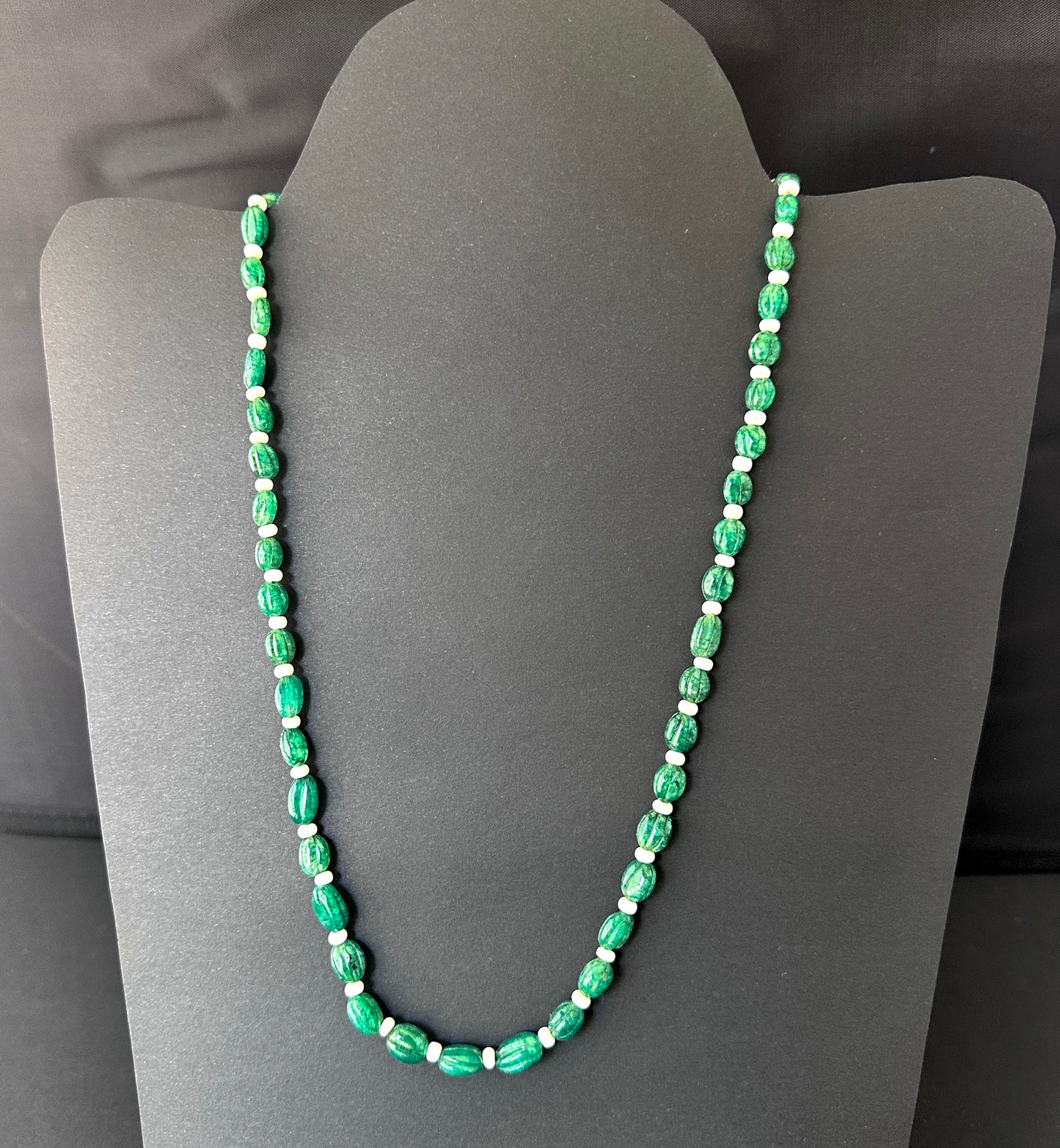 Emerald necklace with natural gemstone beads, carved oval 9–11mm, designed for elegance and versatility.