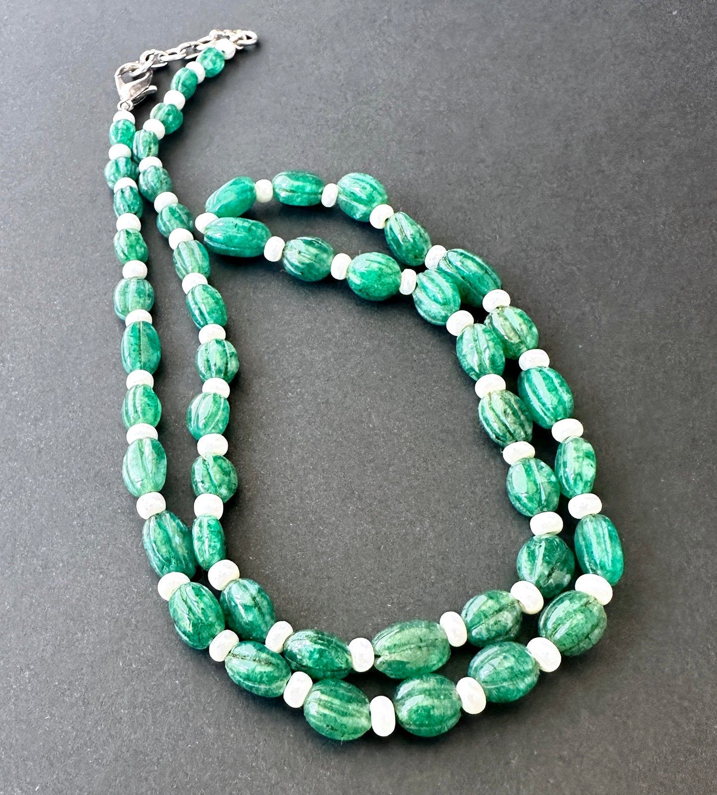 Emerald stone beads necklace, carved oval cut, arranged in a refined strand for timeless style.
