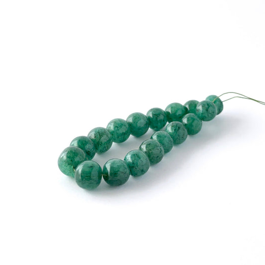 Close view of Emerald smooth round beads showing clarity, texture and premium gemstone quality for DIY jewellery makers.