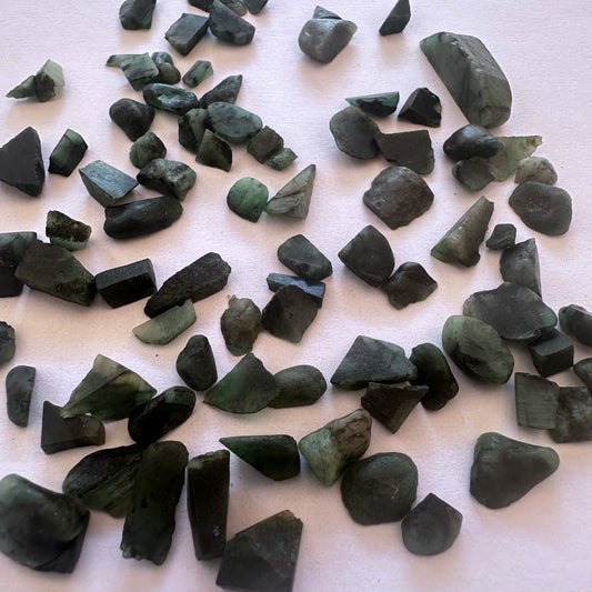Close-up of raw Emerald stones showing natural green colour and uncut surface texture.