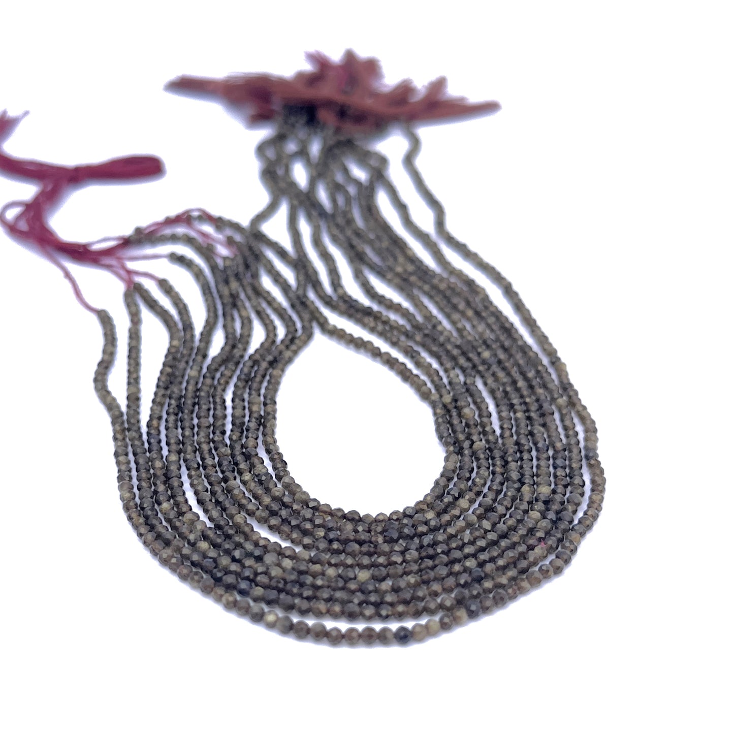 Close-up of Cat’s Eye rondelle beads showing their fine cut and chatoyant glow.