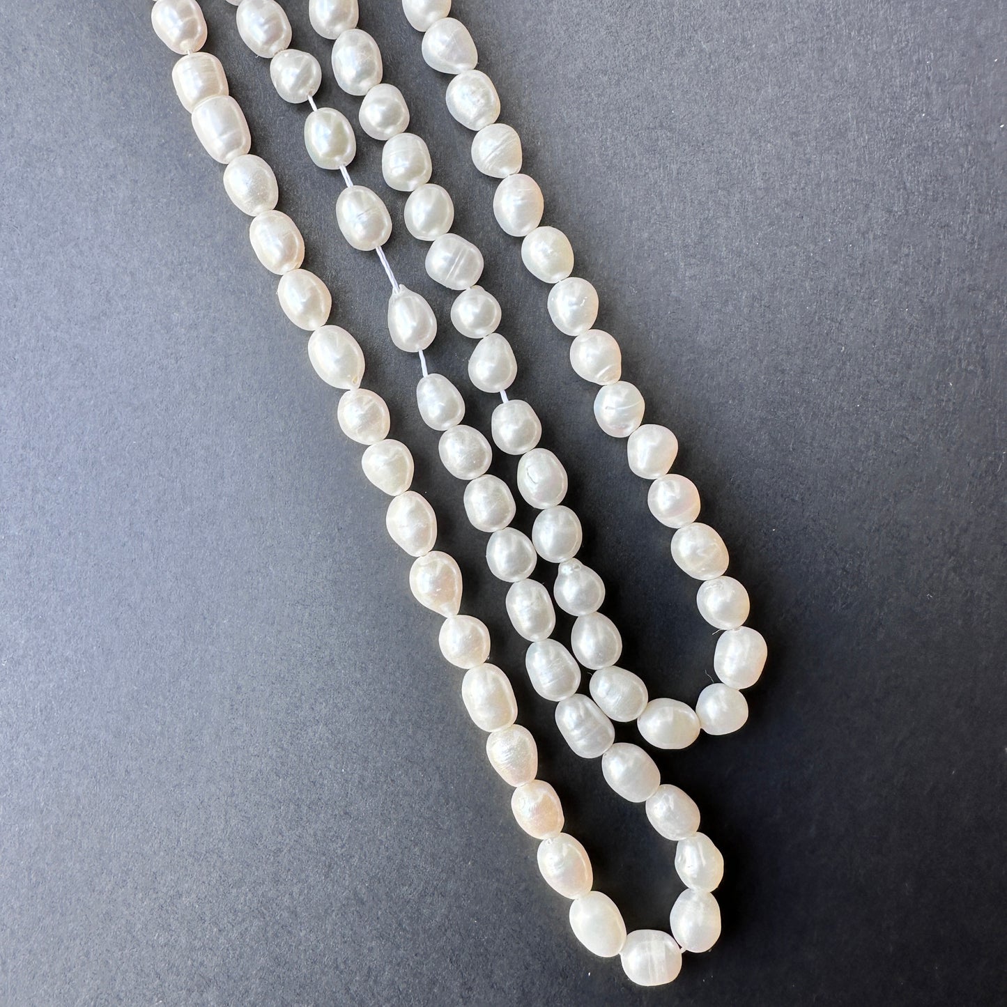 Delicate strands of freshwater pearl beads, showcasing their smooth design.