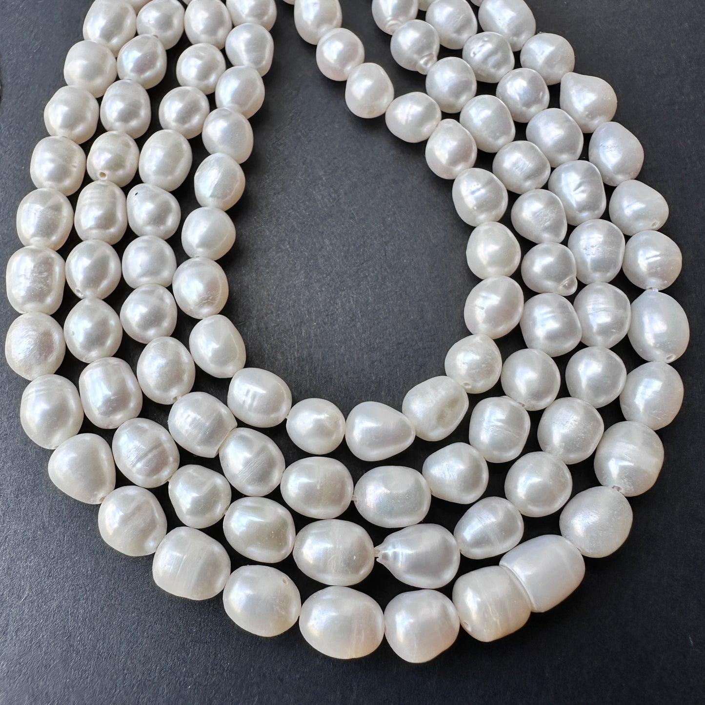 Close-up of natural gemstone beads in pearl white with polished surface and consistent 6mm sizing.