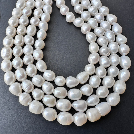 Close-up of natural gemstone beads in pearl white with polished surface and consistent 6mm sizing.