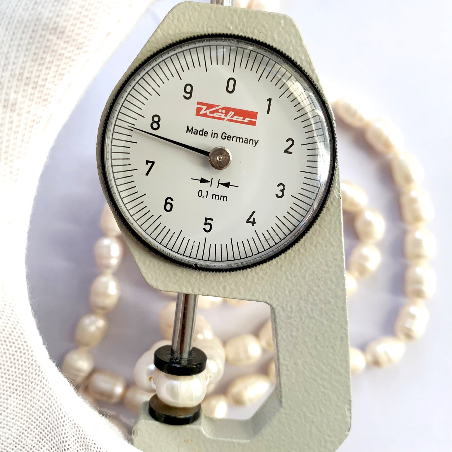 Cream-toned Baroque freshwater pearls glistening in gentle lighting with smooth, uneven textures.