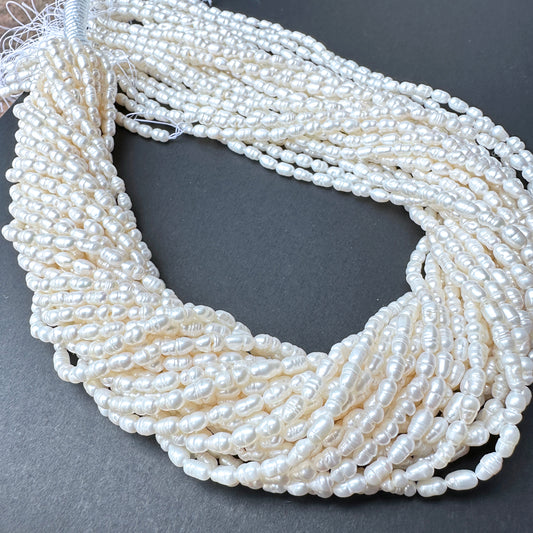 Close-up of baroque rice shaped Freshwater Pearls showing natural texture and sheen.