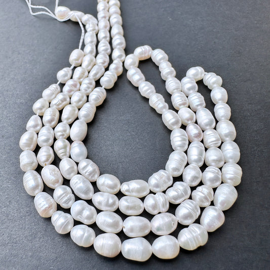 Close-up of baroque rice shaped Freshwater Pearls showing natural texture and sheen.