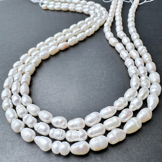 Close-up of baroque rice shaped Freshwater Pearls showing natural texture and sheen.