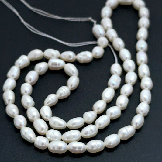 Close‑up of 3.7–3.9mm freshwater pearl beads showing smooth surfaces and natural shine ideal for natural gemstone beads for DIY jewellery.