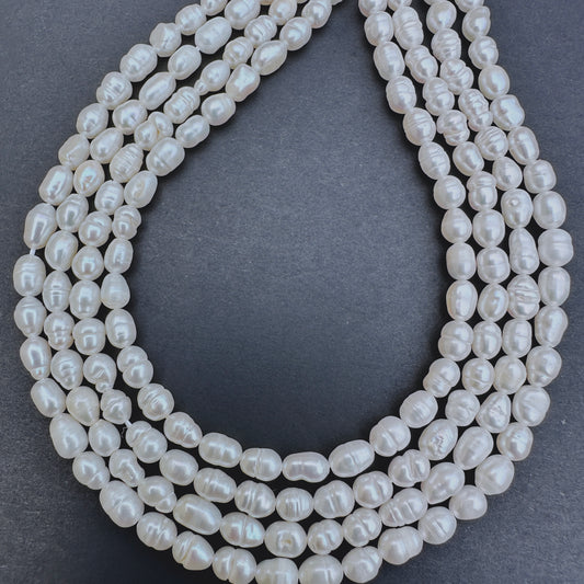 Natural gemstone beads in Freshwater Pearl, arranged on a 33cm strand with consistent rice shape.