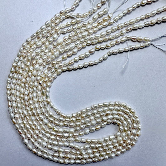 Close-up of 3mm rice-shaped Freshwater Pearls showing consistent cut and gentle lustre.