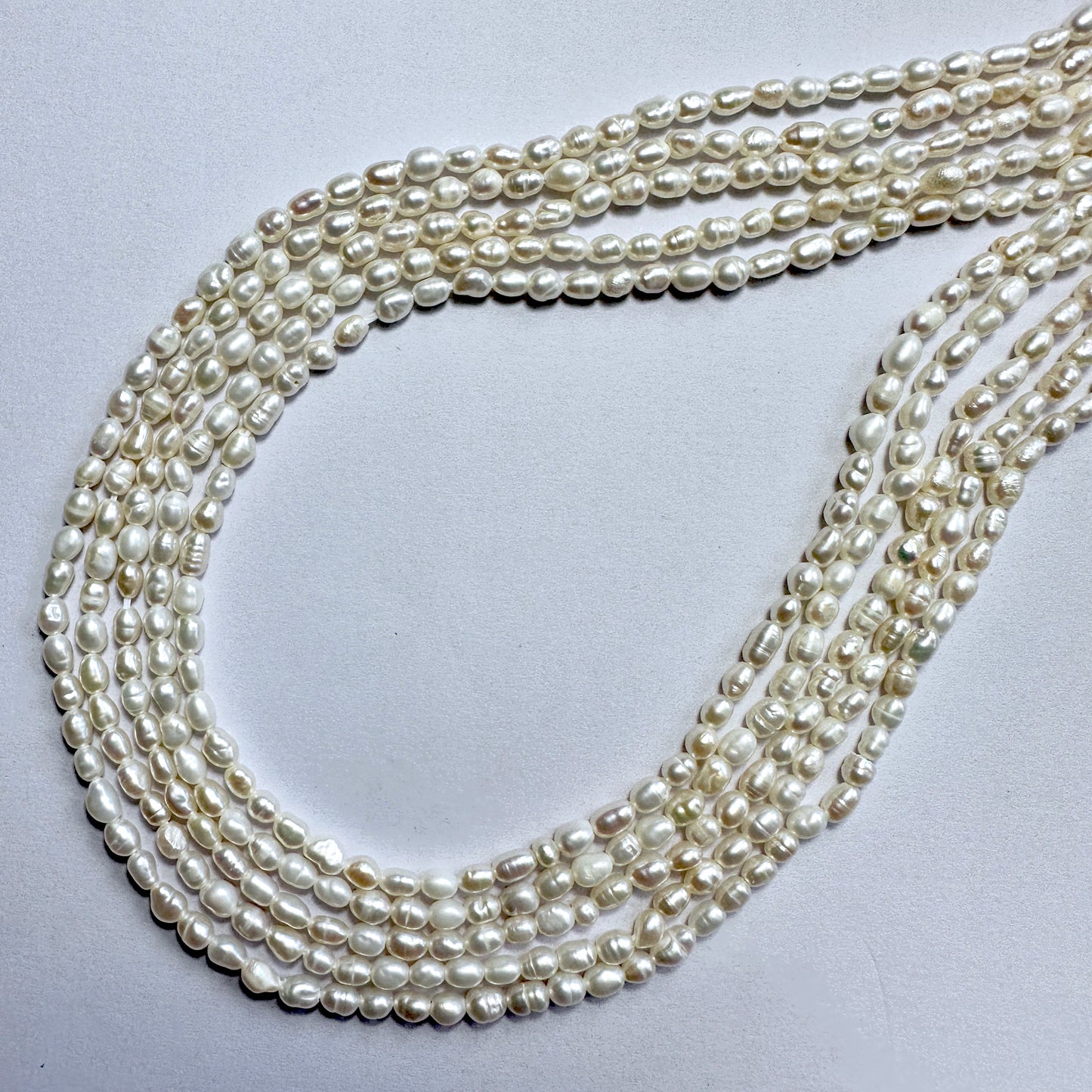 Freshwater rice pearls in 3mm size, arranged on a 35cm strand with soft ivory colour and smooth surface.