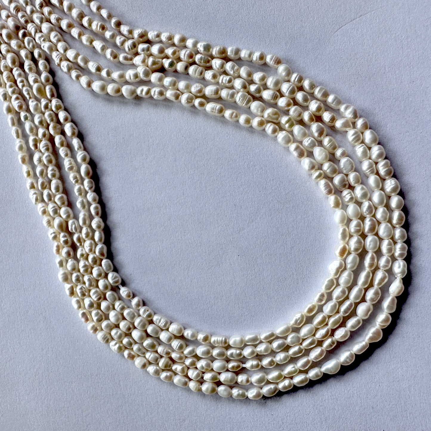 Natural Freshwater Pearls in rice cut, 3mm size, neatly aligned on a 35cm strand.