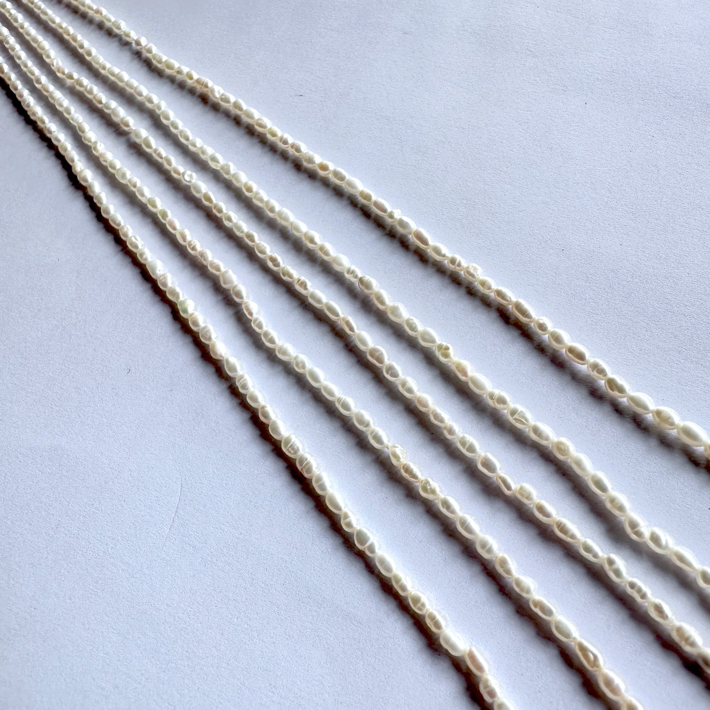 Strand of ivory Freshwater Pearls with rice shape and subtle shine, ideal for fine jewellery making.
