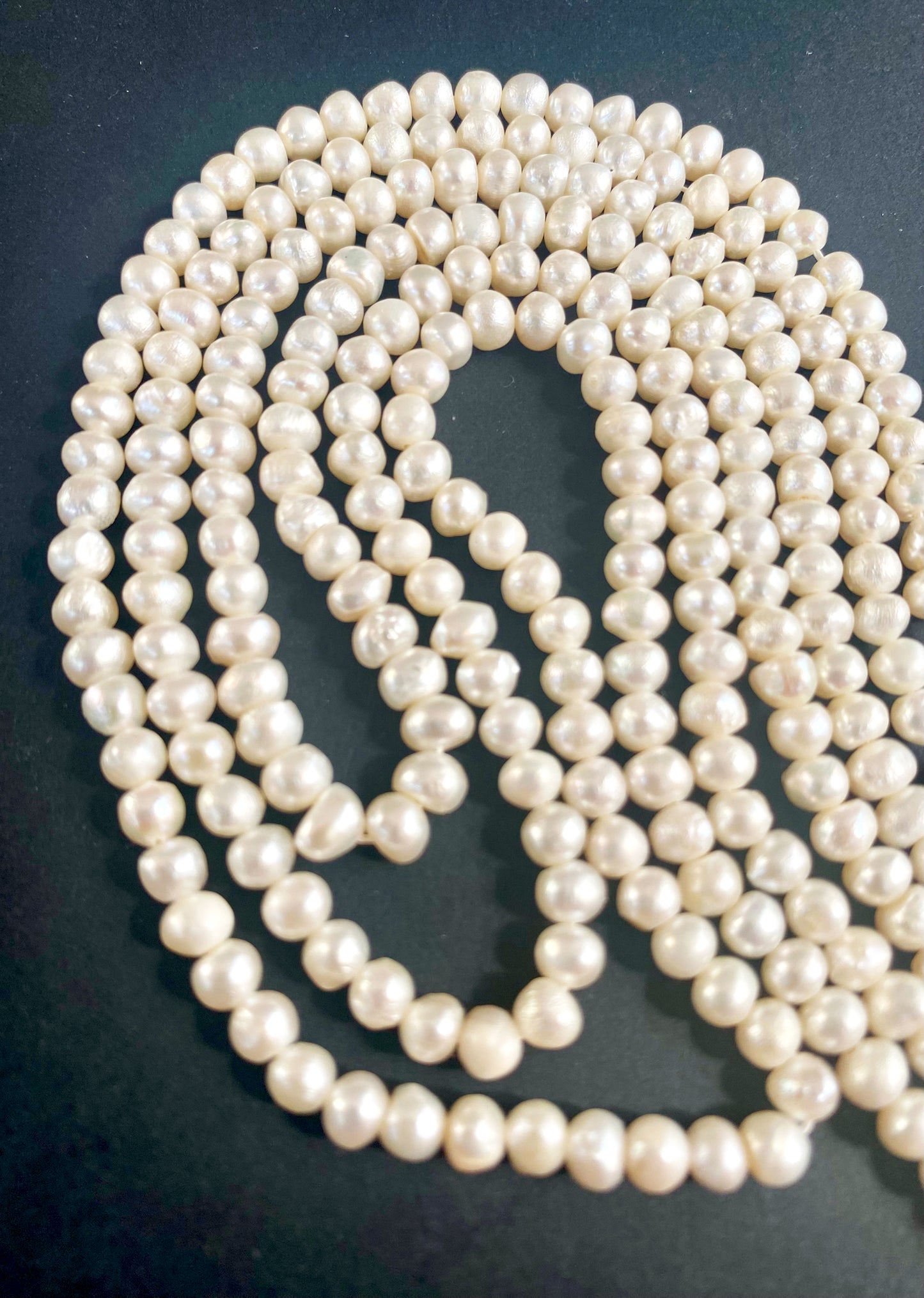 Close-up of 4.5–5mm smooth rondelle Freshwater Pearls with radiant white tones arranged on a 37cm strand.