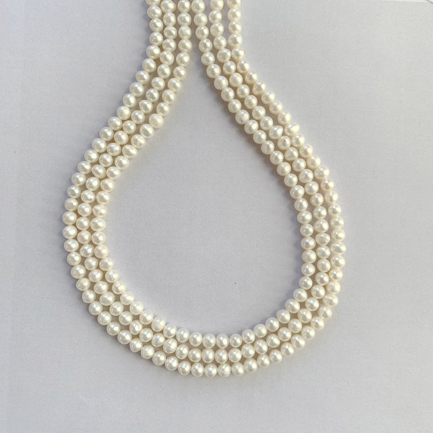 Freshwater pearls in smooth round shape, strung in a neat 40cm line with white lustre.