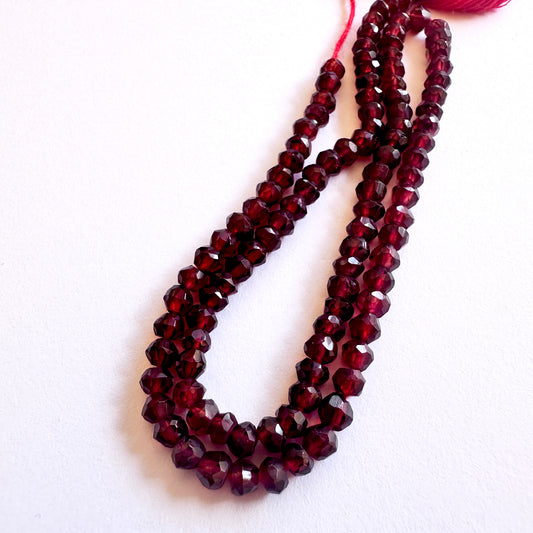 Stone beads featuring Garnet rondelles with polished finish and consistent cut.