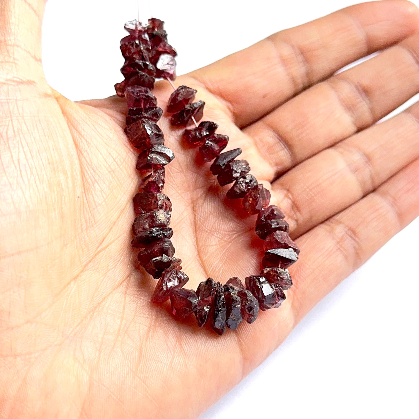 Close‑up of garnet rough stone beads highlighting their organic shape and rich colour for DIY jewellery.