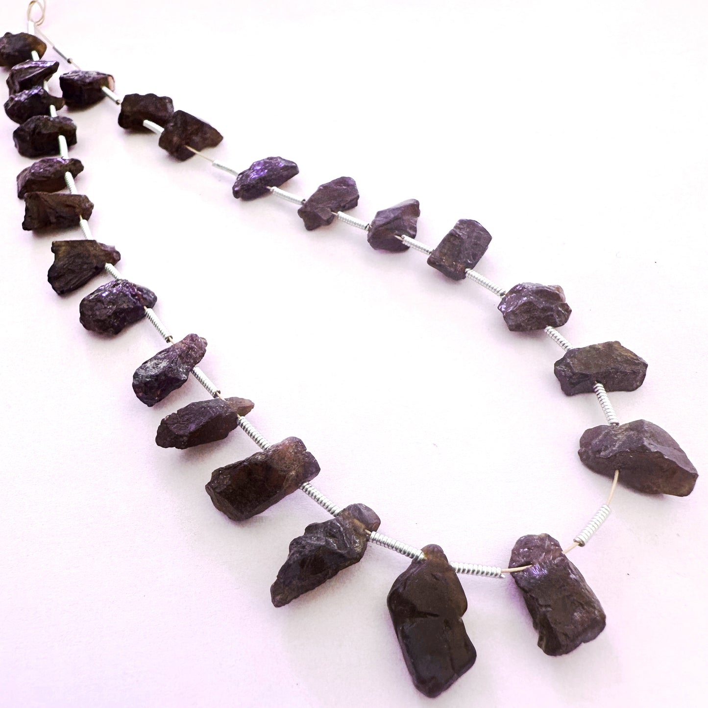 Arrangement of 24 Garnet beads with side-drilled holes and organic shapes in 6-7mm size.