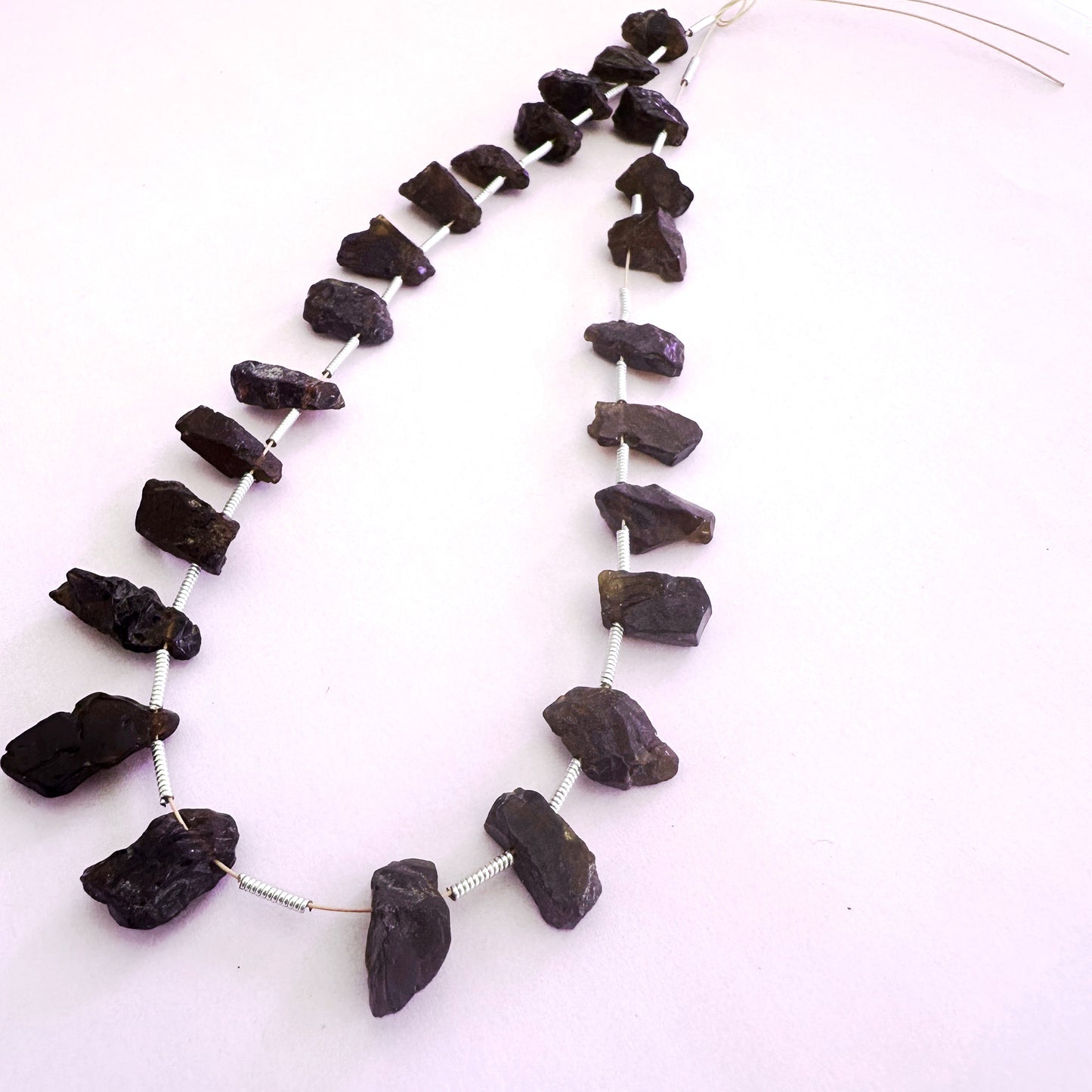 Garnet rough side-drilled beads in 6-7mm size with deep red tones and natural texture, 24 pieces totalling 84 carats.