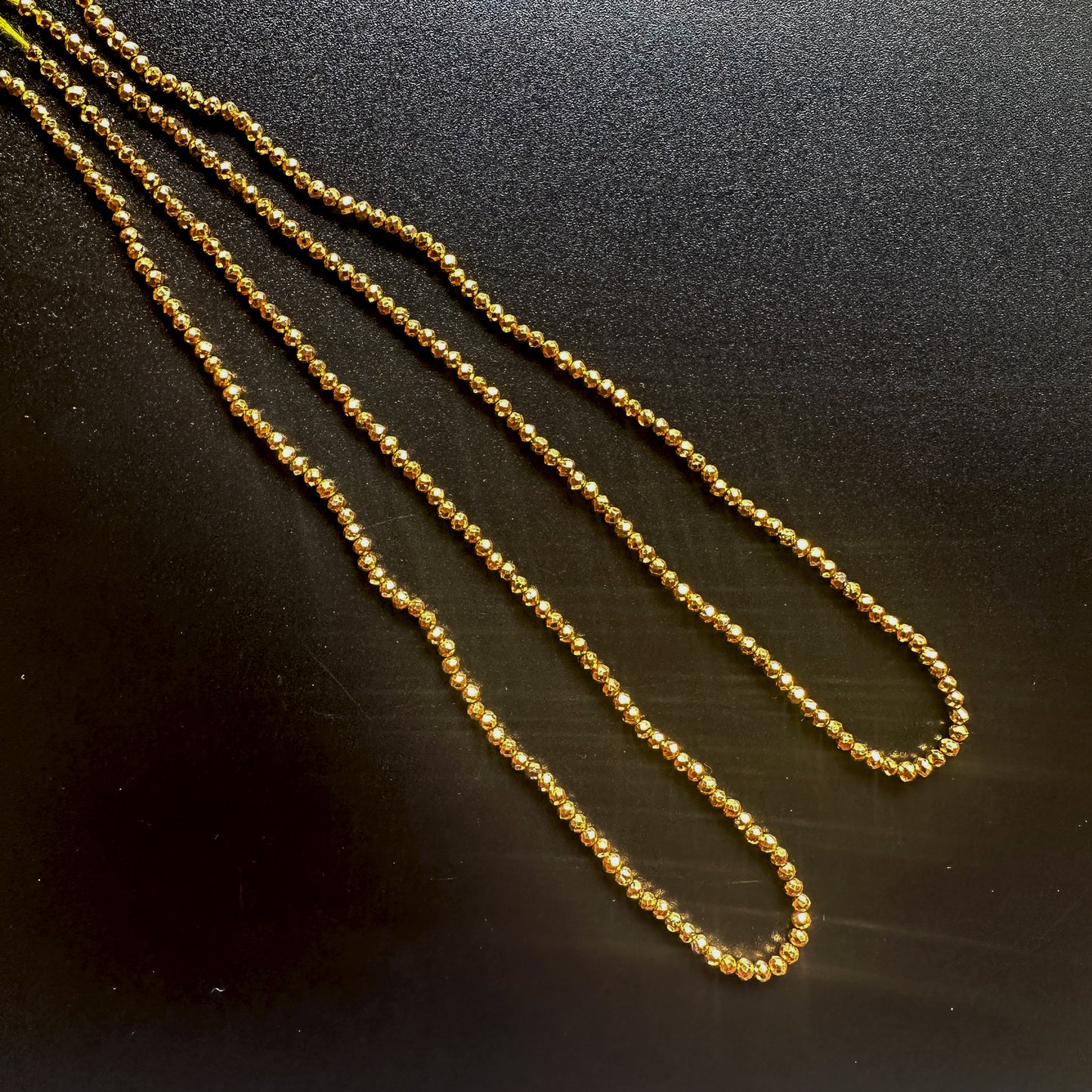 Gold pyrite rondelle beads with faceted cut and metallic gold shine on a 32cm strand.