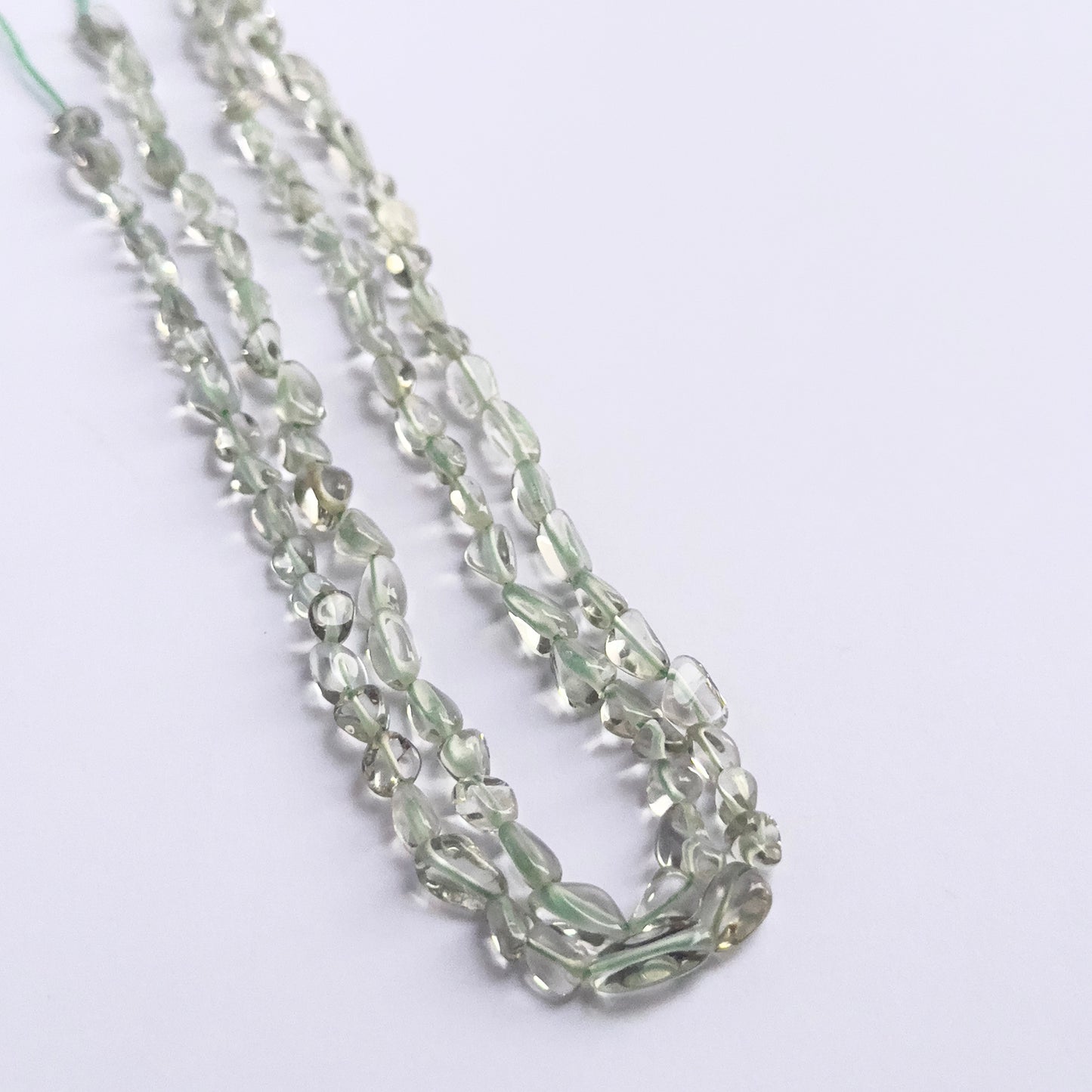Handmade jewellery components featuring Green Amethyst smooth tumble beads strung neatly together.