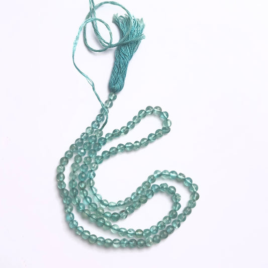 Close-up of Apatite gemstone beads showing smooth round cut and polished finish.