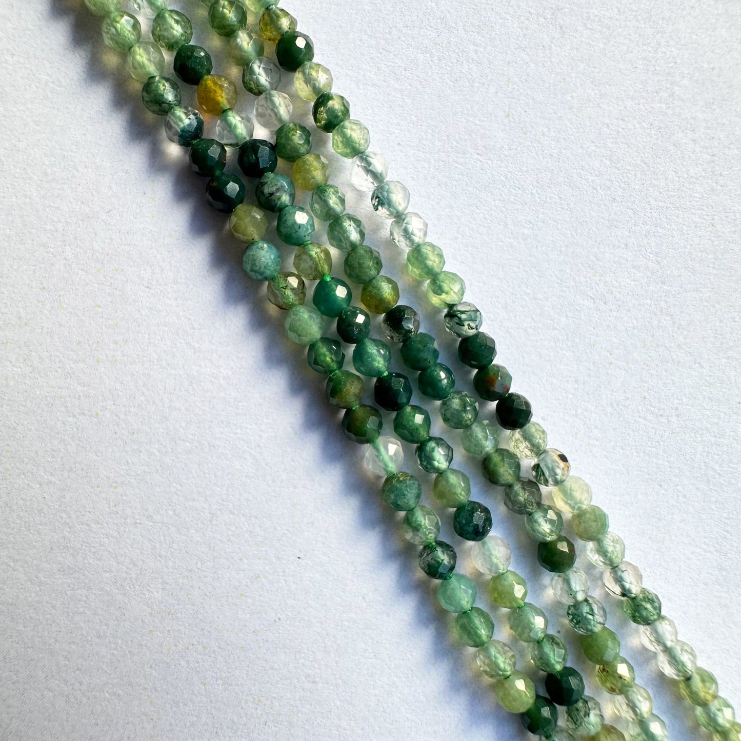 Natural green aventurine beads in rondelle shape, displaying consistent size and polished finish.