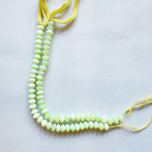 Close-up of Green Opal gemstones showing 7mm size and multi-faceted surface.