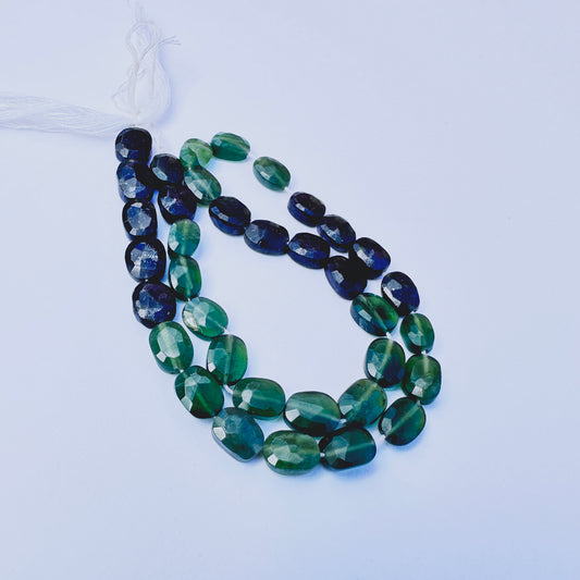 Close-up of Green Tourmaline stone beads showing faceted cut and natural gemstone sparkle.