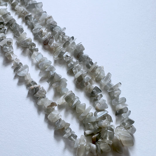 Close-up of Grey Moonstone stone beads showcasing smooth chip shapes and handmade jewellery component quality.