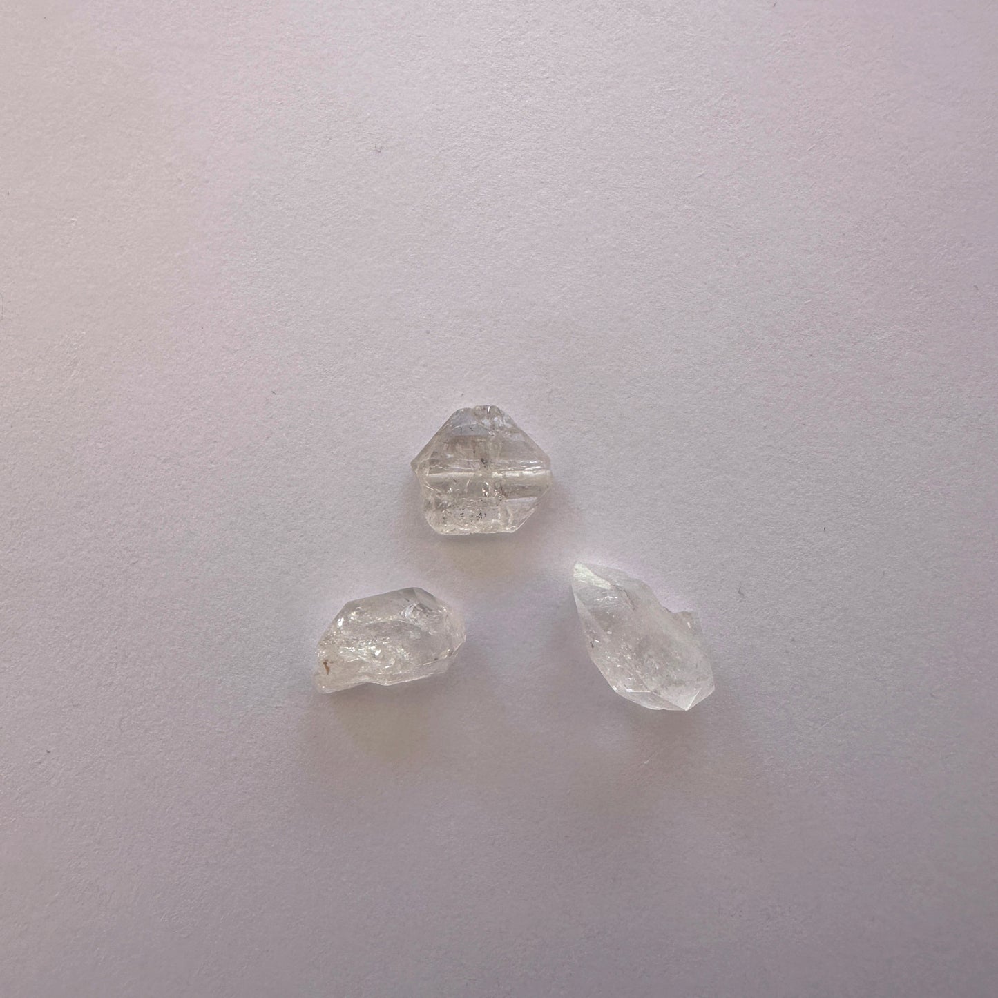 Detailed view of Herkimer undrilled stones with luminous clarity and raw texture