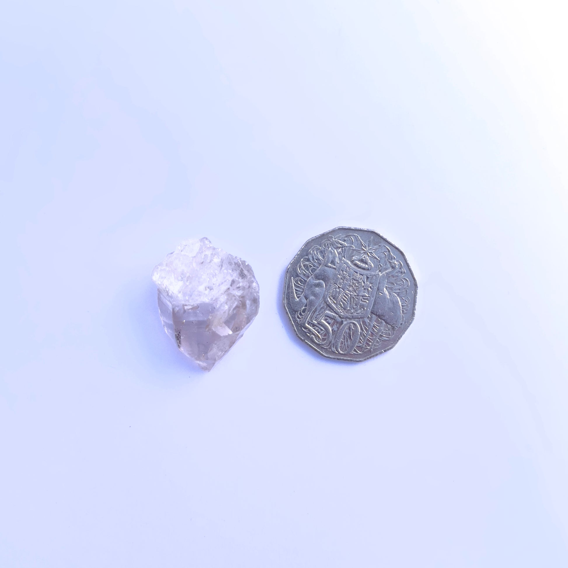Herkimer Diamond rough stone laid flat to highlight its 32×24mm size.