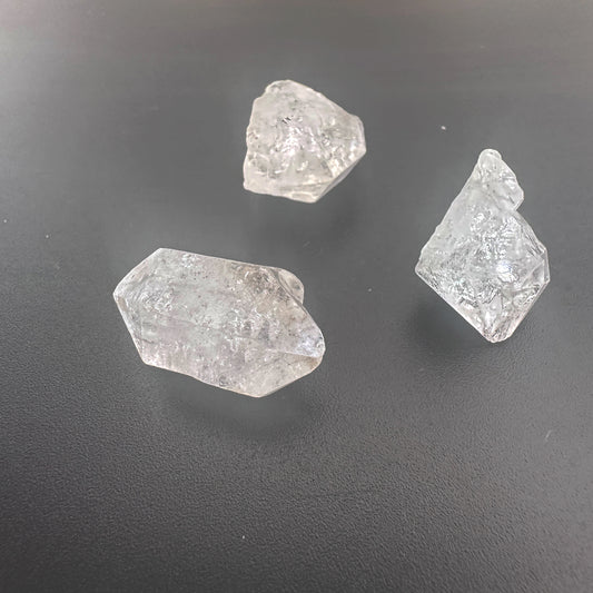 Close-up of raw Herkimer crystals showing double-terminated facets and high transparency.