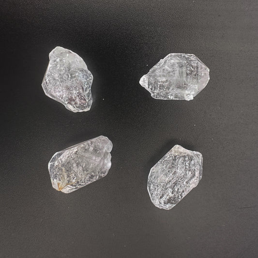 Herkimer diamond nuggets with natural clarity and 13-14mm size in a 4-piece arrangement.