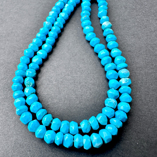 Close-up of Howlite Turquoise stone beads showing faceted cut and gemstone texture.