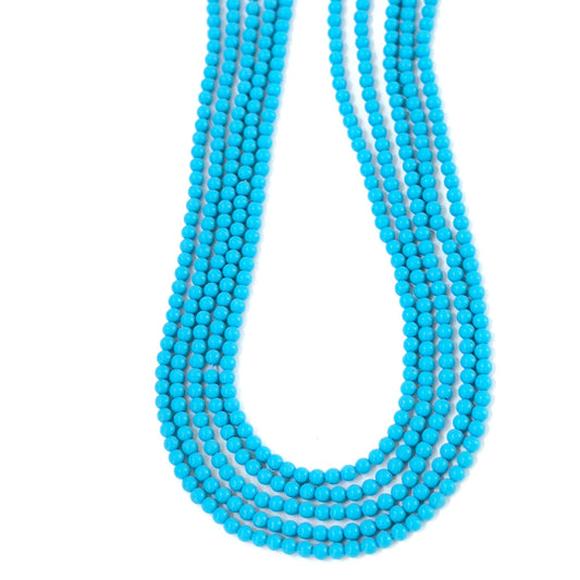 Close‑up of Howlite Turquoise stone beads arranged in a delicate strand.