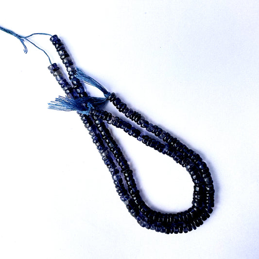 Iolite beads with glossy surface and consistent sizing for elegant jewellery making.