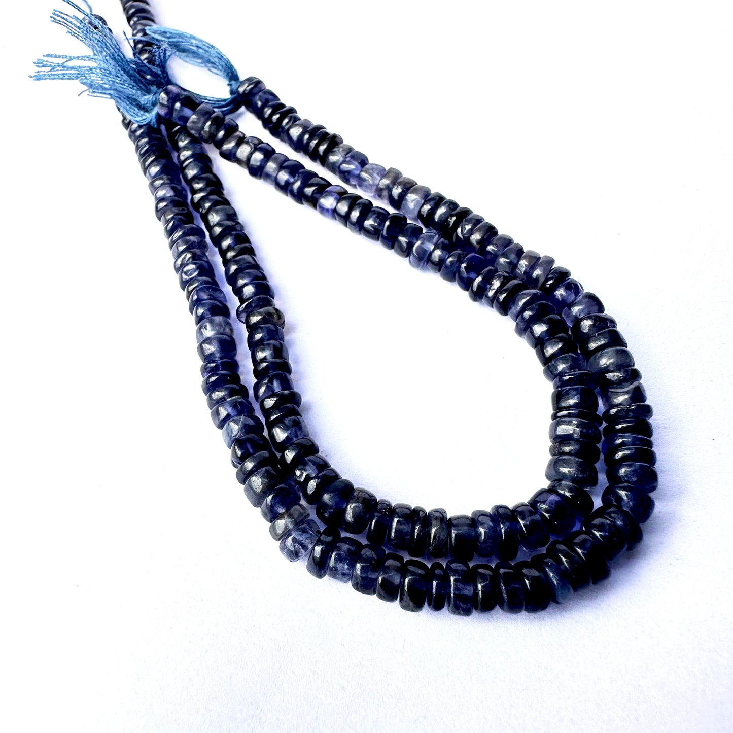 Deep blue Iolite wheel-cut beads with 0.5mm holes for secure threading.